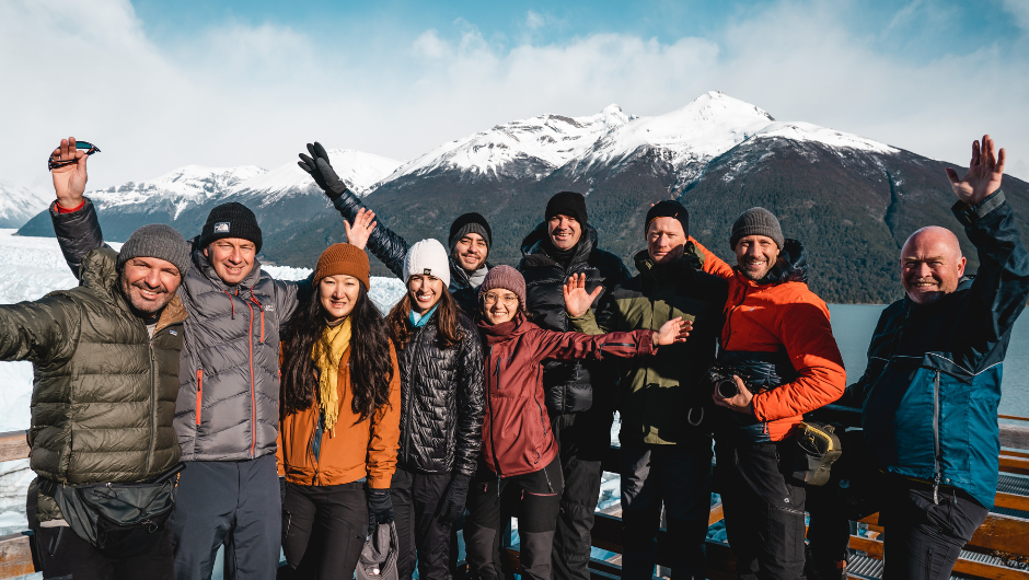 a team booking of charity challengers smiling in front of a mountain