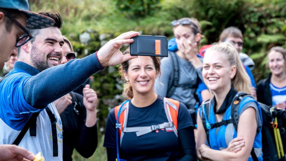 Team of trekkers posing for selfie on charity challenge