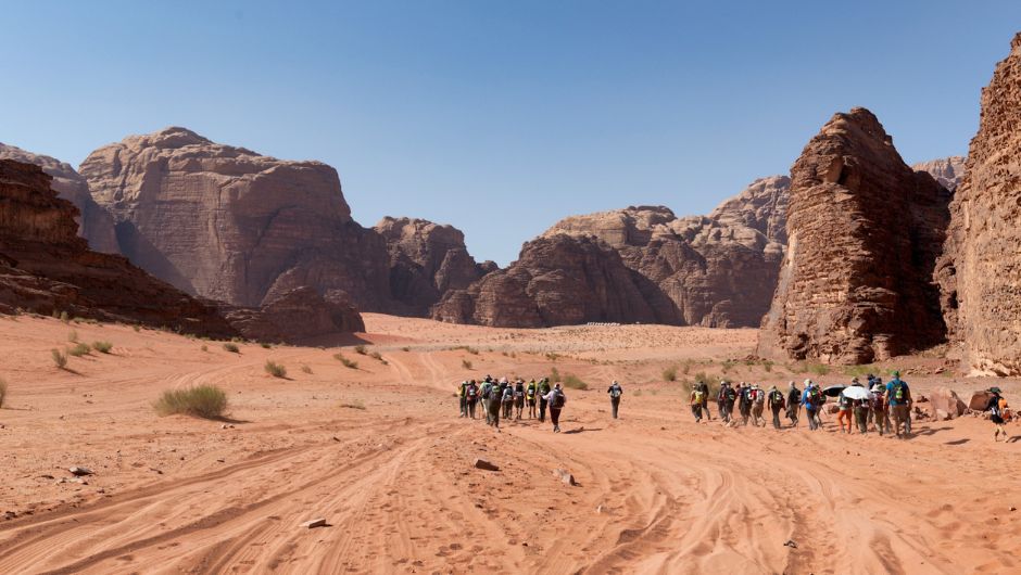 a group of trekkers hiking through Wadi Rum, Jordan