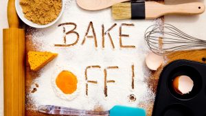 Bake Off wrote in flour on a table with baking equipment