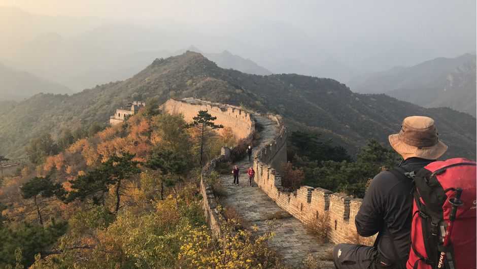 a trekker enjoying the view of the Great Wall of China