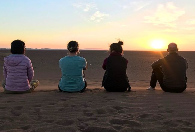 People enjoying sunset in the sahara