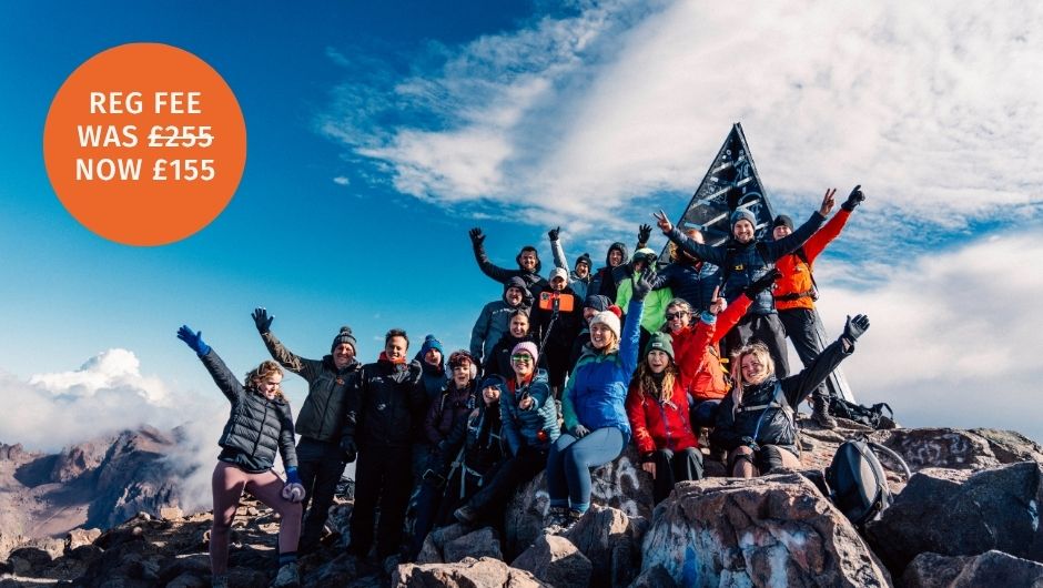 a group of trekkers in the clouds on the summit of Mount Toubkal, Morocco