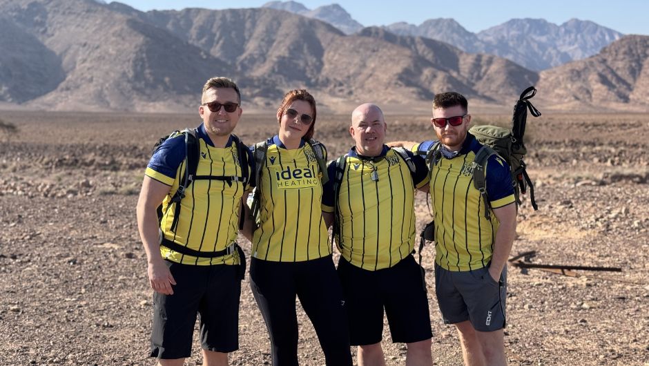 The albion foundation supporters smiling whilst on their charity challenge trek to petra