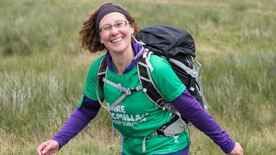 a smiling trekker with her daypack securely fastened