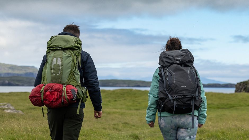 two trekkers hiking with their full packed daypacks