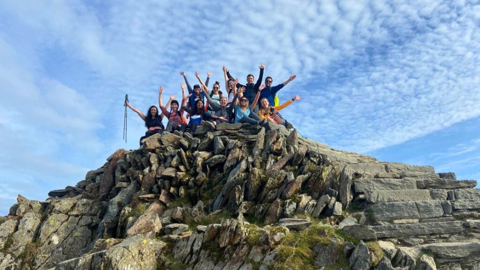 A group of trekkers on the summit of Mt Snowdon, Wales on a clear day