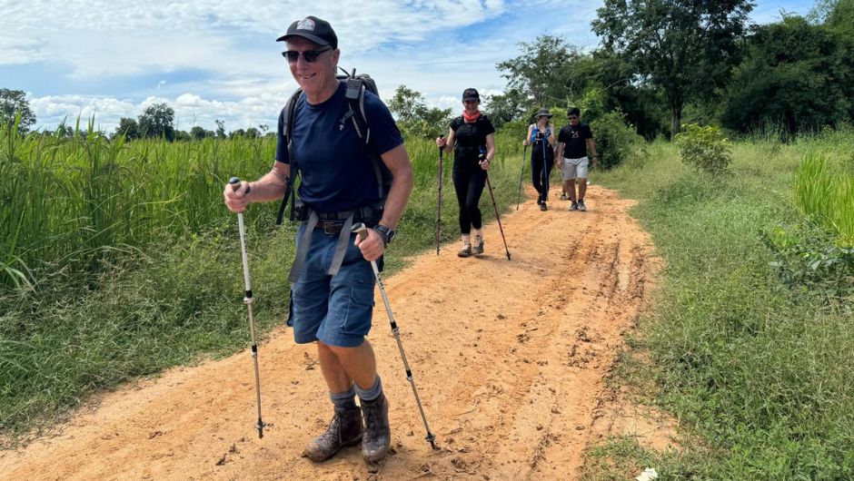 Trekker using walking poles on his charity a challenge to help his knees and joints -   a common complaint and injury on challenges