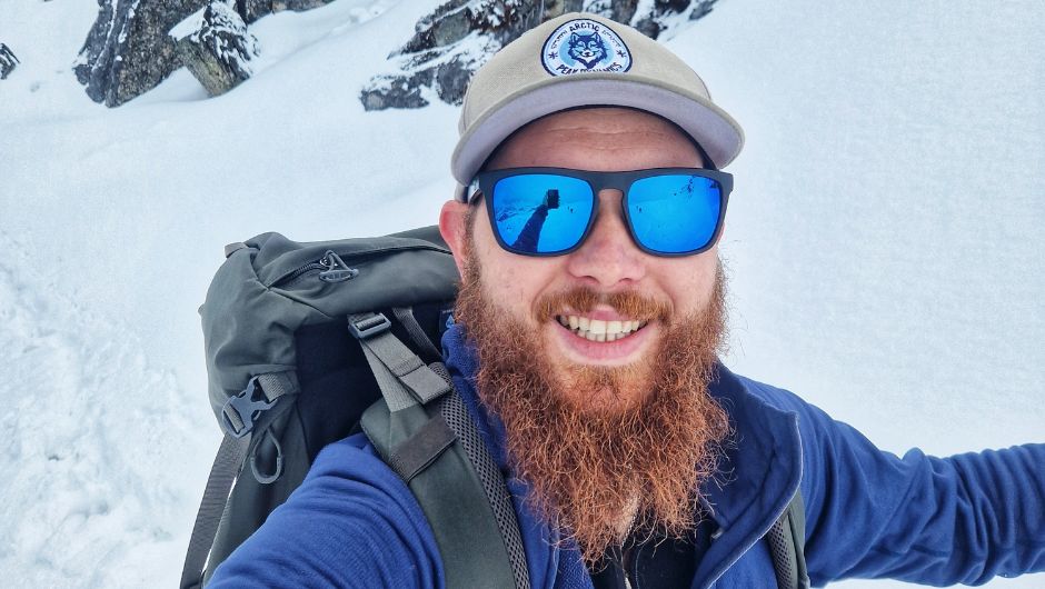 elliot swinney, charity challenge leader smiling whilst on a snowy trek.