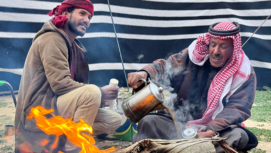 Two local Trek to Petra challenge leaders preparing some traditional hot tea at camp.