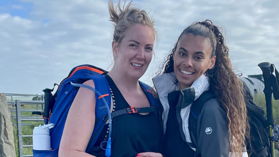 Two people smiling for the camera, dressed to go trekking in the UK.