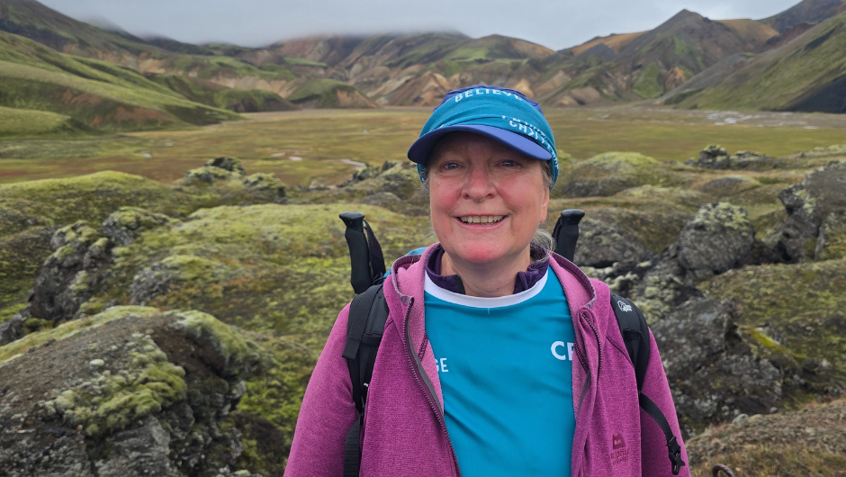 charity challenge leader cari evans stood in front of mossy green rocks and mountains during the icelandic lava trek challenge.