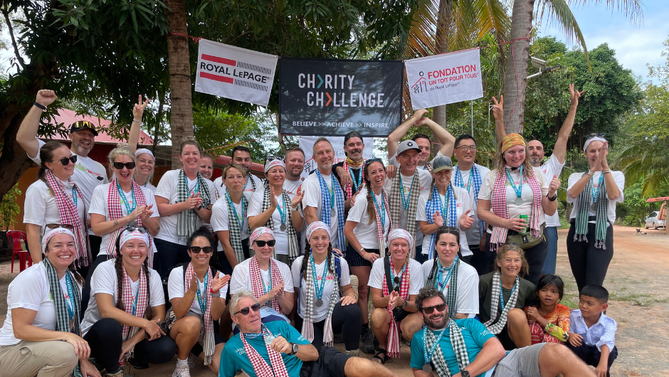 A group of Charity Challenge participants wearing medals and scarfs as they celebrate completing their Cambodia Challenge for Royal LePage Shelter Foundation.