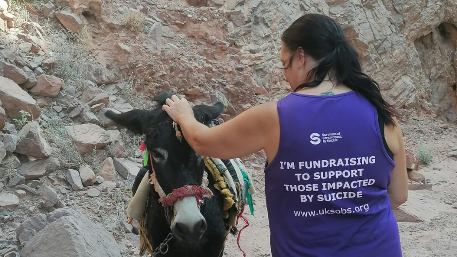 Sharon wearing her Charity T-Shirt and stroking a local mule, whilst on an overseas Charity Challenge trek.