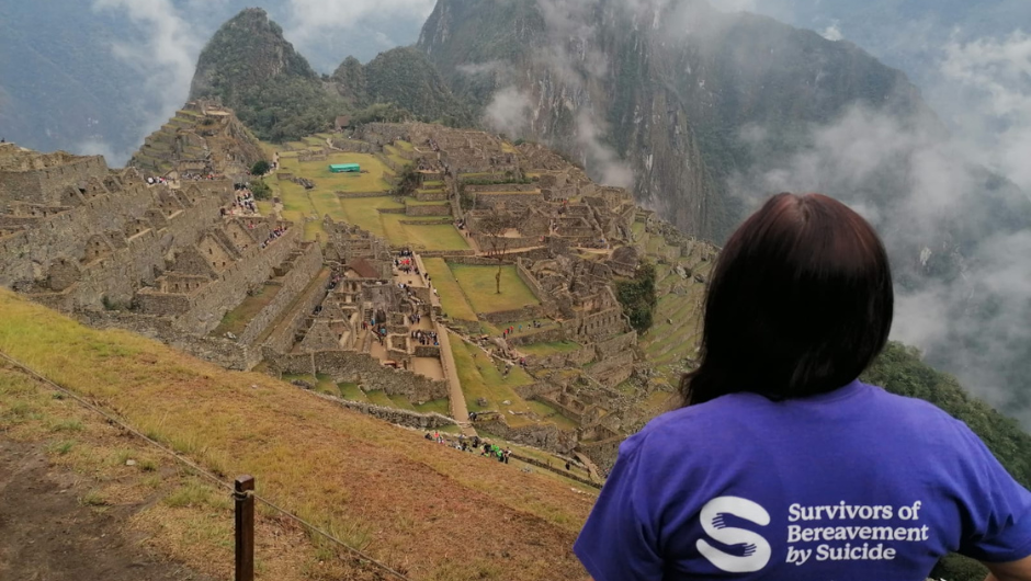 A woman overlooking the site of Machu Picchu, a New Wonder of the Modern World during her Trek to Machu Picchu Challenge.