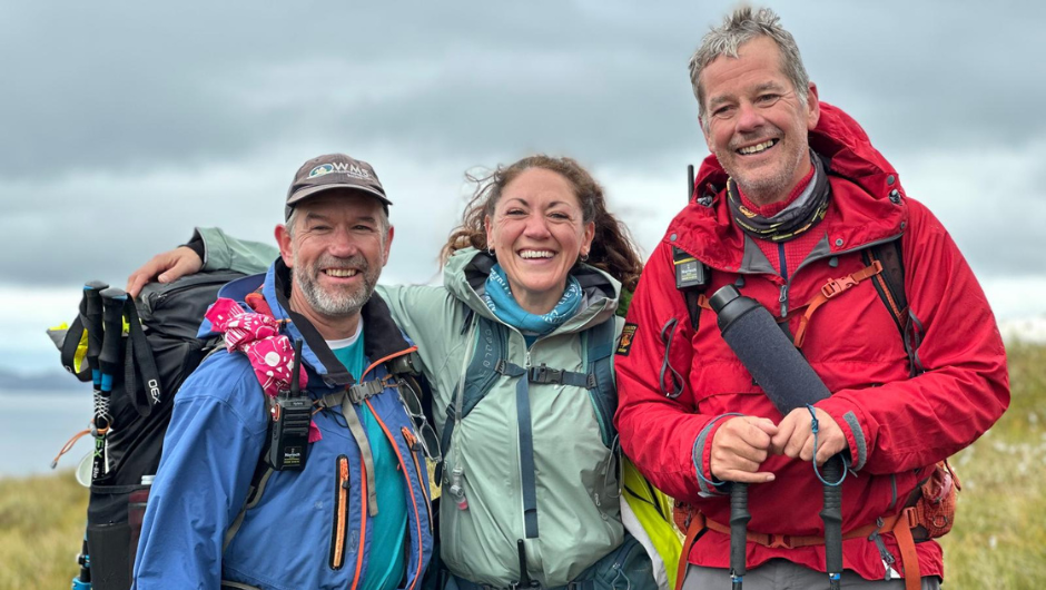 Three Charity Challenge leaders smiling together.