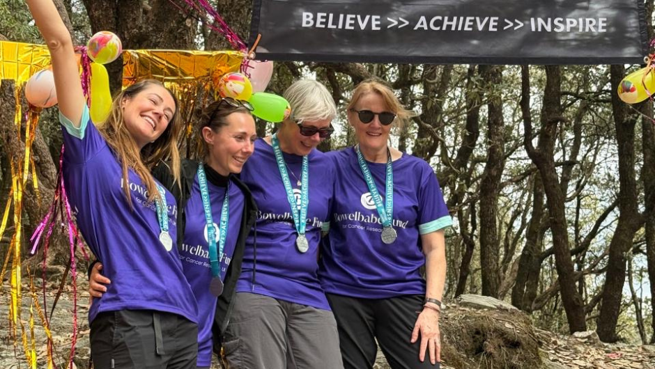 Challenge trekkers celebrating at their finish line, wearing Charity Challenge medals