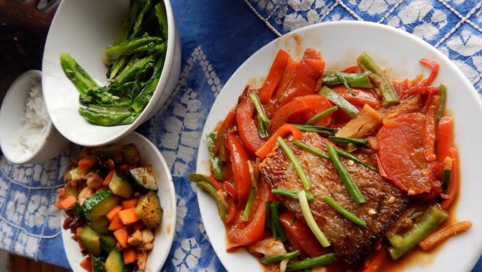 Plates of chinese food presented on table.