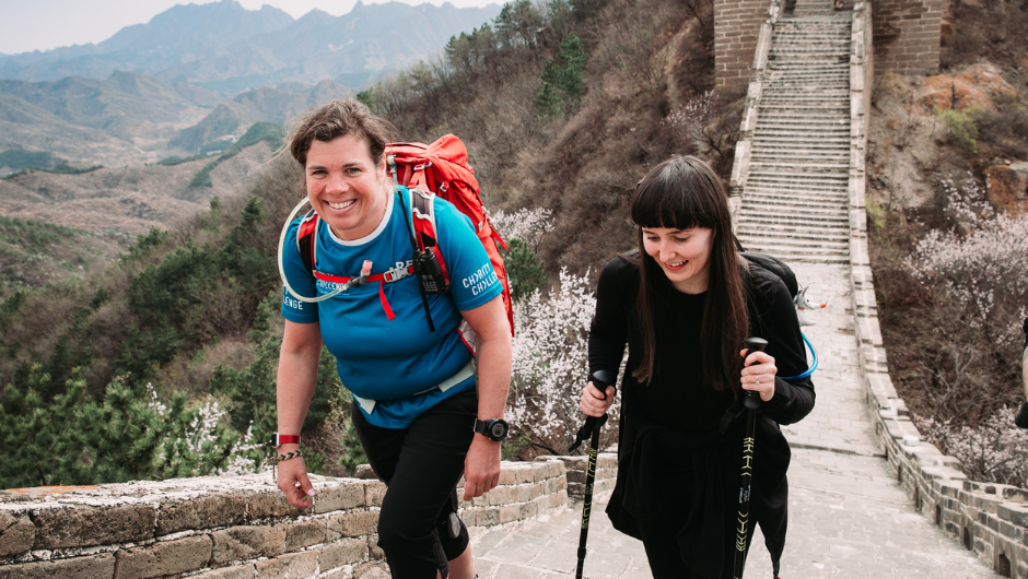 A challenge leader trekking with a participant along a section of the Great Wall of China