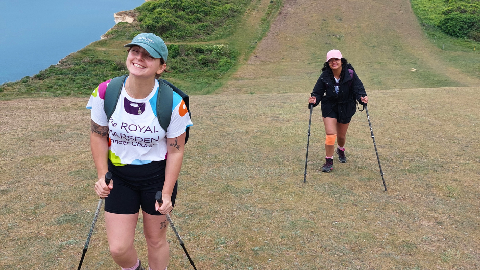 Two trekkers on The royal marsden cancer charity south downs challenge, walking up a steep section of the Seven Sisters Cliffs.