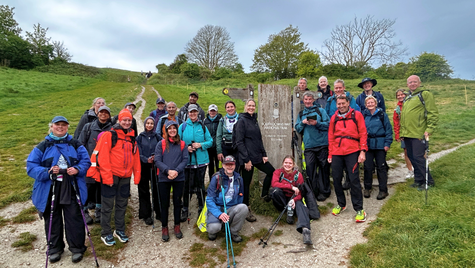 The royal marsden cancer charity supporters posing for a photo next to South Downs Way sign, during their South Downs Challenge.