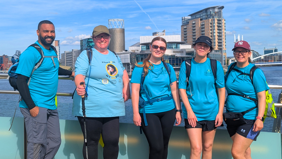 a group of people wearing smiling for a photo during their manchester canals trek with Charity Challenge