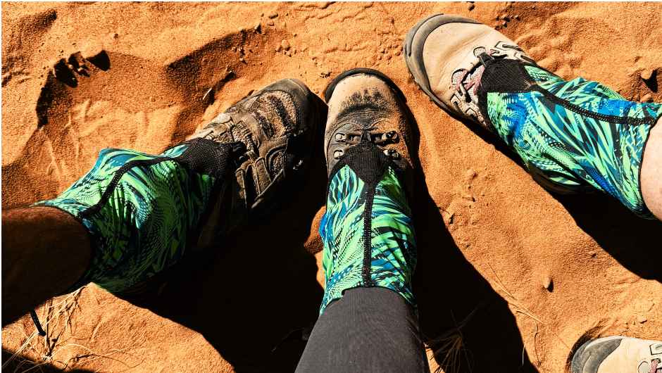 Trekking boots and sand gaiters on sand during a Sahara Desert trek.