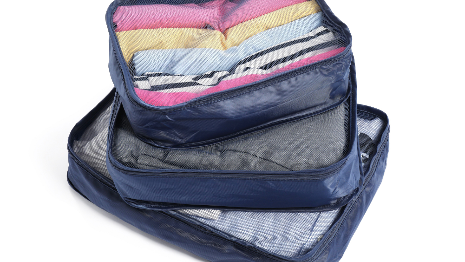 3 different sized packing cubes containing folded clothes