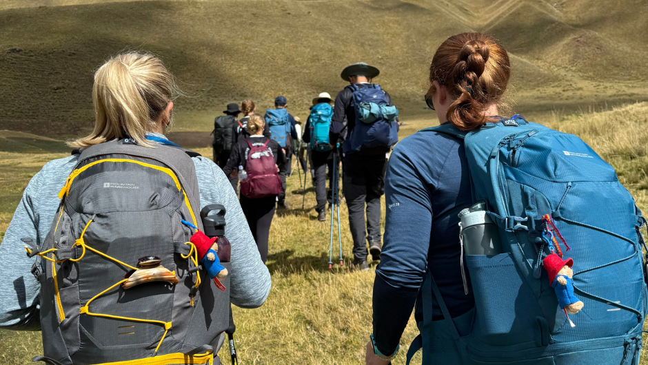 a group of people trekking in Peru, wearing daypacks