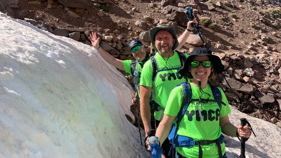 trekkers smiling during the ymca cardiff mount toubkal trek, wearing green YCMA cardiff t-shirts