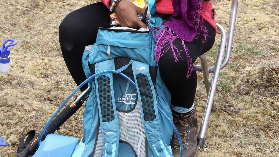 a person looking through their large backpack during a multi-day trekking challenge