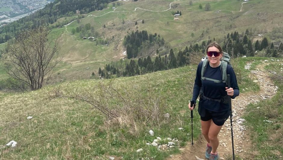A person trekking up a path in the French Alps.