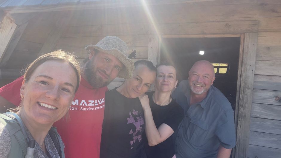 A group of people taking a selfie together outside of a hut in Montengero.